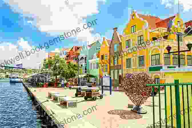 The Colorful Streets Of Willemstad In Curaçao With Pastel Hued Buildings And A Historic Bridge 12MUSTS 2024: The Caribbean Magazine Michelle Lawson